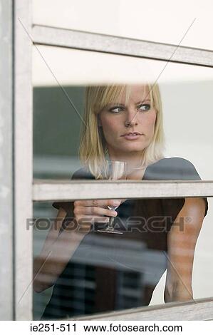 Woman by window with wine glass View Large Photo Image Stock Image - Woman by window with wine glass. Fotosearch