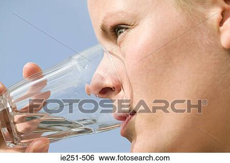 Woman drinking water View Large Photo Image Stock Photograph - Woman drinking water. Fotosearch