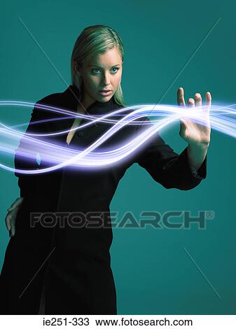 Stock Image - Woman touching light. Fotosearch