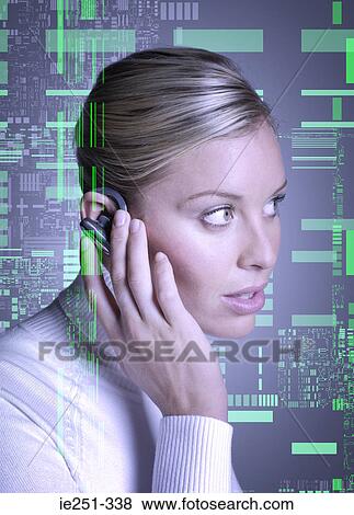 Stock Photo - Woman wearing hands free device. Fotosearch
