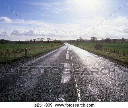 Road through fields View Large Photo Image Stock Photo - Road through fields. Fotosearch