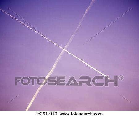 Stock Image - Vapour trails in purple sky. Fotosearch