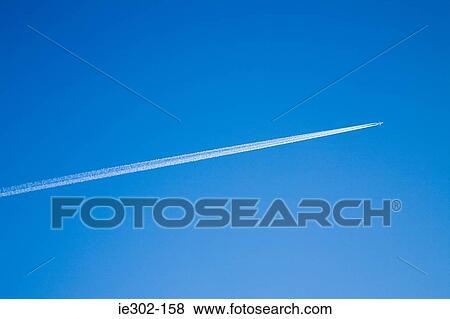 Airplane and vapour trail View Large Photo Image Stock Photo - Airplane and vapour trail. Fotosearch