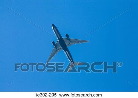 Stock Photography - Airplane in blue sky. Fotosearch