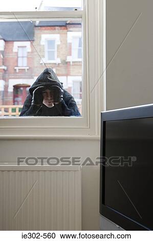 Burglar looking through window View Large Photo Image Stock Image - Burglar looking through window. Fotosearch