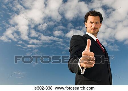 Businessman giving thumbs up View Large Photo Image Stock Photo - Businessman giving thumbs up. Fotosearch