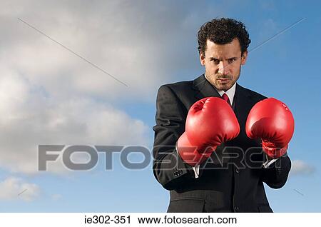 Businessman wearing boxing gloves View Large Photo Image Stock Image - Businessman wearing boxing gloves. Fotosearch