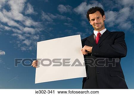 Businessman with blank sign View Large Photo Image Stock Image - Businessman with blank sign. Fotosearch