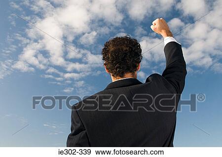 Businessman with raised fist View Large Photo Image Stock Photo - Businessman with raised fist. Fotosearch