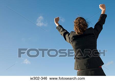 Businesswoman with arms raised View Large Photo Image Stock Photograph - Businesswoman with arms raised. Fotosearch