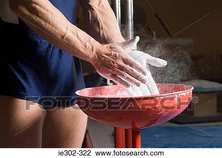 Gymnast putting chalk on his hands View Large Photo Image Stock Image - Gymnast putting chalk on his hands. Fotosearch
