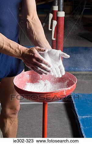 Gymnast putting chalk on his hands View Large Photo Image Stock Image - Gymnast putting chalk on his hands. Fotosearch