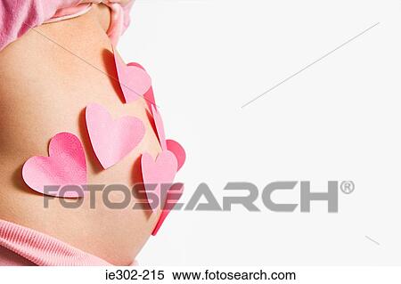 Hearts on pregnant womans stomach View Large Photo Image Stock Photography - Hearts on pregnant womans stomach. Fotosearch