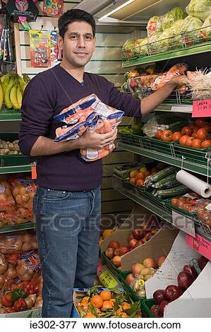 Man in grocery shop View Large Photo Image Stock Photo - Man in grocery shop. Fotosearch
