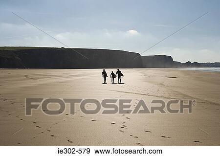 Surfers on a beach View Large Photo Image Stock Photo - Surfers on a beach. Fotosearch