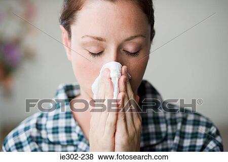 Stock Photo - Woman blowing her nose. Fotosearch