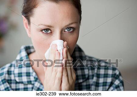 Woman blowing her nose View Large Photo Image Stock Photo - Woman blowing her nose. Fotosearch