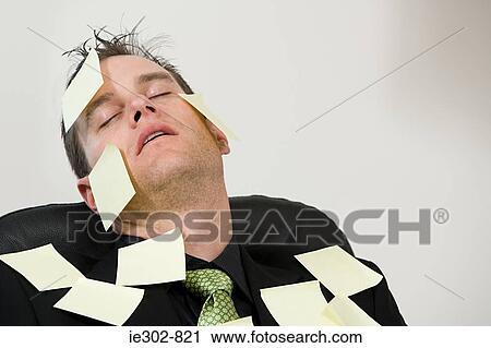 Stock Image - A businessman covered in adhesive notes. Fotosearch