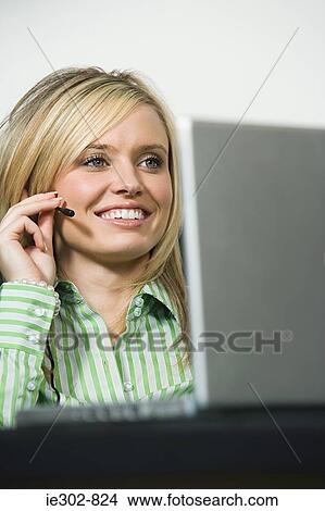 A telephonist wearing a headset View Large Photo Image Picture - A telephonist wearing a headset. Fotosearch