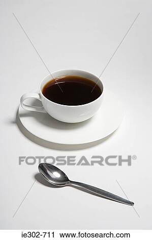 Cup of coffee and a spoon View Large Photo Image Stock Image - Cup of coffee and a spoon. Fotosearch