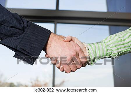 Man and woman shaking hands View Large Photo Image Stock Image - Man and woman shaking hands. Fotosearch