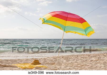 A parasol on a beach View Large Photo Image Stock Photograph - A parasol on a beach. Fotosearch