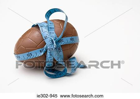 A tape measure tied round an easter egg View Large Photo Image Stock Photography - A tape measure tied round an easter egg. Fotosearch