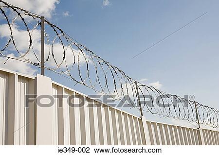 Barbed wire and a fence View Large Photo Image Stock Image - Barbed wire and a fence. Fotosearch