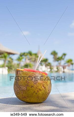 Cocktail in a coconut View Large Photo Image Stock Photo - Cocktail in a coconut. Fotosearch
