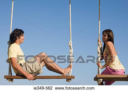 Couple on swings View Large Photo Image Stock Image - Couple on swings. Fotosearch