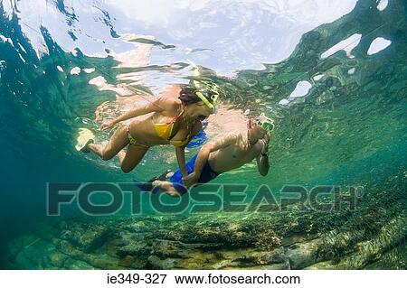 Stock Photo - Couple snorkelling. Fotosearch