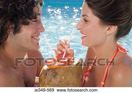 Stock Photo - Couple with coconut cocktail. Fotosearch
