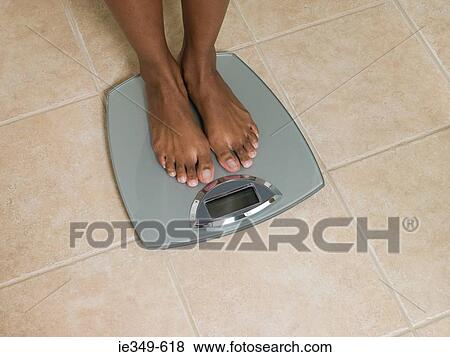 Feet of woman on scales View Large Photo Image Stock Photo - Feet of woman on scales. Fotosearch