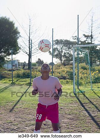 Footballer heading the ball View Large Photo Image Stock Photo - Footballer heading the ball. Fotosearch