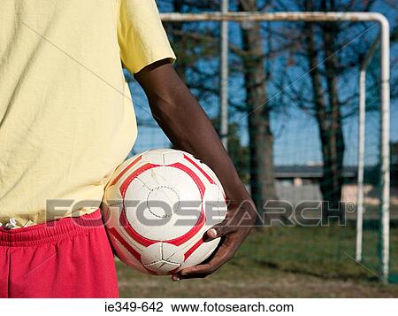 Footballer with a football View Large Photo Image Stock Image - Footballer with a football. Fotosearch