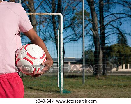 Footballer with a football View Large Photo Image Stock Photo - Footballer with a football. Fotosearch