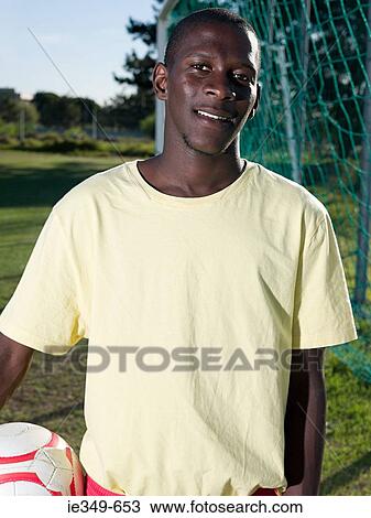 Stock Image - Footballer with football. Fotosearch
