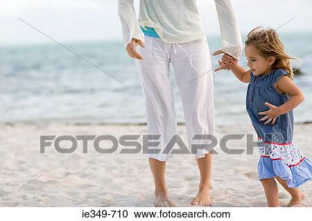Girl and mother on beach View Large Photo Image Stock Image - Girl and mother on beach. Fotosearch