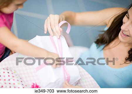 Girl and mother with birthday gift View Large Photo Image Stock Image - Girl and mother with birthday gift. Fotosearch