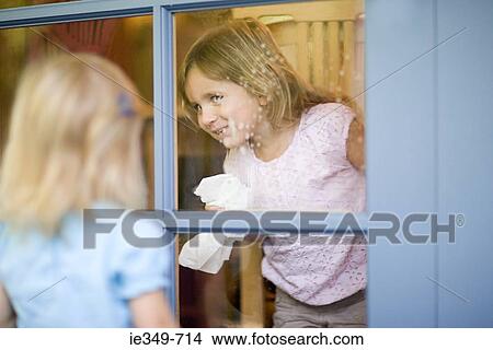 Girl cleaning window View Large Photo Image Picture - Girl cleaning window. Fotosearch
