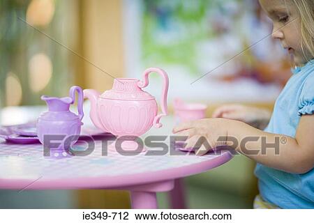 Stock Image - Girl having tea party. Fotosearch