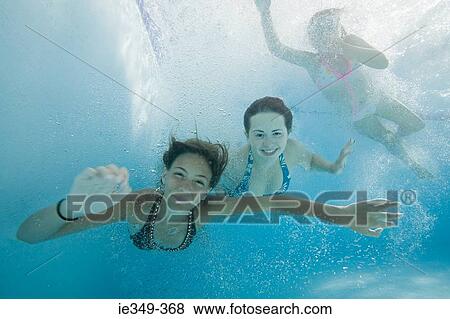 Girls swimming in pool View Large Photo Image Stock Photo - Girls swimming in pool. Fotosearch