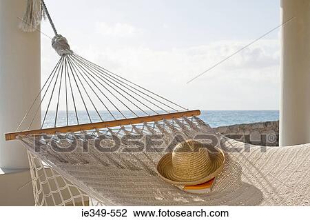 Hat and book on hammock View Large Photo Image Stock Image - Hat and book on hammock. Fotosearch