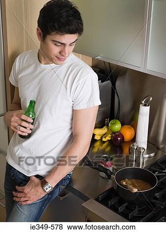 Man cooking soup and drinking beer View Large Photo Image Stock Photo - Man cooking soup and drinking beer. Fotosearch