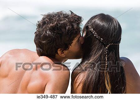 Stock Photo - Man kissing girlfriend. Fotosearch