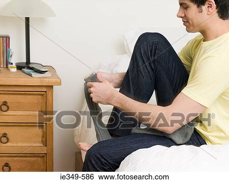 Man putting on socks View Large Photo Image Stock Photograph - Man putting on socks. Fotosearch