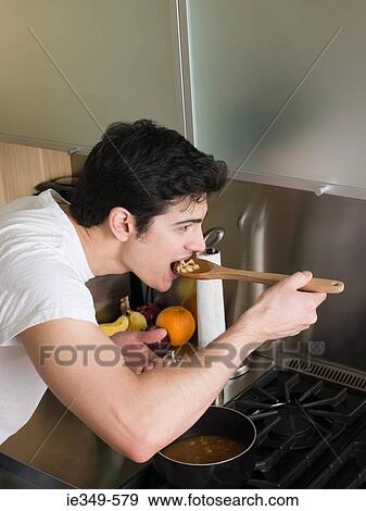 Man tasting soup View Large Photo Image Stock Photo - Man tasting soup. Fotosearch