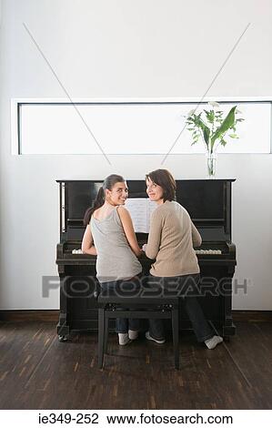 Mother and daughter at piano View Large Photo Image Stock Image - Mother and daughter at piano. Fotosearch