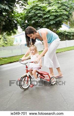 Mother and daughter on tricycle View Large Photo Image Stock Image - Mother and daughter on tricycle. Fotosearch
