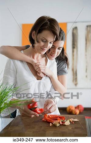 Stock Photo - Mother and daughter preparing food. Fotosearch
